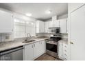 Bright kitchen featuring white cabinetry, stainless steel appliances and modern countertops at 1784 E Torrey Pines Ln, Chandler, AZ 85249