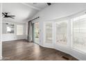 Bright living room featuring wood flooring, ceiling fans, and large windows at 1784 E Torrey Pines Ln, Chandler, AZ 85249