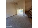 Expansive living area with vaulted ceiling, new carpeting and staircase leading to the second floor at 1813 E Sheena Dr, Phoenix, AZ 85022