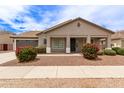 Inviting single-story home showcasing lovely desert landscaping and a cozy, covered front porch at 18614 E Oriole Way, Queen Creek, AZ 85142