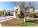 Lovely single-story home with a well-maintained lawn, desert landscaping and an inviting arched entryway at 20496 W Valley View Dr, Buckeye, AZ 85396