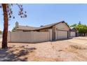 Single level home showing the garage and courtyard wall at 2164 S Estrella Cir, Mesa, AZ 85202