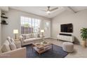 Bright living room featuring a large window, ceiling fan and comfortable furniture at 2301 E University Dr # 172, Mesa, AZ 85213