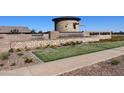 Community entrance featuring a stone water feature, landscaping, and clear signage during the day at 23036 E Oriole Way, Queen Creek, AZ 85142