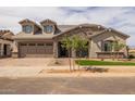 Beautiful two-story home with stone facade, three-car garage, and drought-tolerant landscaping at 23036 E Oriole Way, Queen Creek, AZ 85142