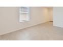 Bright bedroom features tile flooring, blinds, and neutral paint ready for customization at 25109 N 174Th Ln, Surprise, AZ 85387