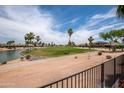 Scenic view of a golf course and a pond under a blue sky with fluffy clouds at 3441 N 162Nd Ln, Goodyear, AZ 85395