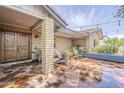 Inviting brick patio with comfortable seating and shaded pergola, ideal for relaxation at 402 E Claremont St, Phoenix, AZ 85012