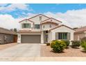 Attractive two-story home boasting a red tile roof, a two-car garage, and a meticulously kept front yard with vibrant landscaping at 4142 E Sandy Way, Gilbert, AZ 85297