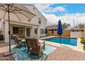 Inviting backyard with a sparkling pool, comfortable lounge chairs, and shade umbrellas, creating a perfect outdoor retreat at 4142 E Sandy Way, Gilbert, AZ 85297
