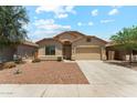 Charming single-story home featuring a well-maintained front yard and a two-car garage at 43884 W Kramer Ln, Maricopa, AZ 85138