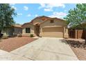 Well-kept single-story home with desert landscaping and a spacious driveway leading to a garage at 43884 W Kramer Ln, Maricopa, AZ 85138