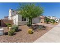 Beautifully landscaped front yard with desert landscaping and mature tree at 5330 W Thresher Way, Laveen, AZ 85339