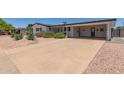 Well-maintained, single story home featuring desert landscaping, a long driveway, and a spacious carport in a quiet neighborhood at 701 N 55Th Pl, Mesa, AZ 85205