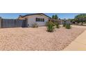 A low-maintenance desert landscape adds to the curb appeal of this charming, single-story residence with a painted brick exterior at 701 N 55Th Pl, Mesa, AZ 85205
