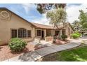 Charming single-story home featuring a landscaped front yard with desert landscaping, textured stucco, and a covered entryway at 8140 N 107Th Ave # 287, Peoria, AZ 85345
