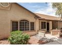 Charming single-story home featuring a landscaped front yard with desert landscaping, textured stucco, and a covered entryway at 8140 N 107Th Ave # 287, Peoria, AZ 85345