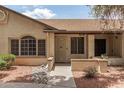 Charming single-story home featuring a landscaped front yard with desert landscaping, textured stucco, and a covered entryway at 8140 N 107Th Ave # 287, Peoria, AZ 85345