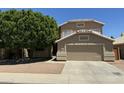 Charming two-story home with a well-maintained lawn and a spacious two-car garage at 113 N Albert Dr, Chandler, AZ 85226