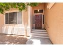 Inviting front entrance with a classic wood door, stylish lighting, and well-kept landscaping at 113 N Albert Dr, Chandler, AZ 85226