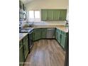 Bright kitchen featuring granite countertops, green cabinets and modern stainless steel appliances at 113 N Albert Dr, Chandler, AZ 85226