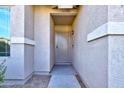 Close-up of the home's front entry featuring a security screen door and desert-toned stucco at 13170 W Clarendon Ave, Litchfield Park, AZ 85340