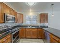 Well-lit kitchen boasting stainless steel appliances, wood cabinets, tile backsplash, and granite countertops at 1610 W Maplewood St, Chandler, AZ 85286
