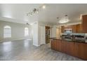 Open floor plan with tile flooring connecting the living area to the kitchen with stainless appliances at 1610 W Maplewood St, Chandler, AZ 85286