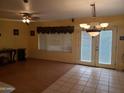 Bright living room featuring wood-laminate flooring, chandelier, and sliding glass doors at 1623 E Fremont Rd, Phoenix, AZ 85042