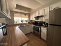 Functional kitchen with stainless steel appliances, tile backsplash, and bright natural light at 2209 W Los Arboles Pl, Chandler, AZ 85224