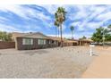 Charming home with desert landscaping and sidewalk on a sunny day showing excellent curb appeal at 2821 E Larkspur Dr, Phoenix, AZ 85032