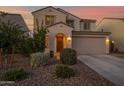 Exterior view of a well-maintained home featuring an arched entryway and meticulously landscaped front yard at 32347 N Vernal Ln, San Tan Valley, AZ 85144