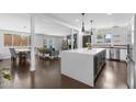 Open-concept kitchen featuring a large island with counter seating and stainless steel appliances at 3402 E Sells Dr, Phoenix, AZ 85018