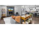 Modern living room with fireplace, and comfortable seating, connected to kitchen at 3402 E Sells Dr, Phoenix, AZ 85018