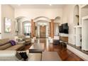 Open-concept living room with archways, wood floors, and comfortable seating at 35108 N 139Th Way, Scottsdale, AZ 85262