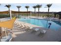 Community pool and lounge area with comfortable seating under shaded canopies at 3758 E Gold Mountain Ave, San Tan Valley, AZ 85143