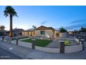 Attractive exterior of home with desert landscaping, manicured lawn, and solar panels at 4202 W Purdue Ave, Phoenix, AZ 85051