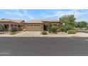 Attractive single-Gathering home featuring a two-car garage, tile roof, and mature landscaping at 4404 W Ellis St, Laveen, AZ 85339