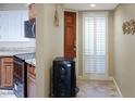 Inviting entryway with tile flooring, shuttered window, and paneled door at 4718 W Sanna St, Glendale, AZ 85302