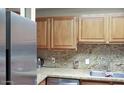 Well-lit kitchen features wood cabinets and sleek countertops at 4718 W Sanna St, Glendale, AZ 85302