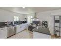 Kitchen featuring modern appliances, white cabinetry, dark countertops, and mosaic backsplash at 520 S Macdonald --, Mesa, AZ 85210