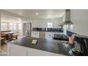 Kitchen featuring white cabinets, stainless steel appliances, and a dark countertop island at 520 S Macdonald --, Mesa, AZ 85210
