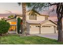 Charming two-story home with a well-manicured lawn and an attached three-car garage at 521 N Cambridge St, Gilbert, AZ 85233