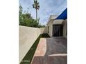 Backyard featuring faux turf, a tall palm tree and a brick paver patio at 5308 N 2Nd Ave, Phoenix, AZ 85013