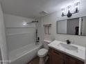 Updated bathroom showcasing a combination tub and shower, with gray and white finishes, plus modern fixtures at 5308 N 2Nd Ave, Phoenix, AZ 85013