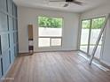 Bedroom featuring wood-look floors, large windows, a blue accent wall, and sliding glass patio doors at 5308 N 2Nd Ave, Phoenix, AZ 85013