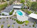 Aerial view of backyard pool, outdoor kitchen and seating area surrounded by expertly manicured grounds at 6310 E Desert Cove Ave, Scottsdale, AZ 85254