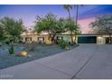 Single-story home featuring desert landscaping, long driveway and a 3 car garage at 6310 E Desert Cove Ave, Scottsdale, AZ 85254