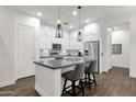 Modern kitchen with white cabinets, stainless steel appliances, and a stylish breakfast bar at 6565 E Thomas Rd # 1096, Scottsdale, AZ 85251