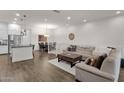 Bright, open living area featuring hardwood floors, neutral decor, and comfortable furnishings at 6565 E Thomas Rd # 1096, Scottsdale, AZ 85251